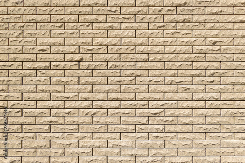 Close-up detail of a sand brick wall texture for background. Horizontal masonry.
