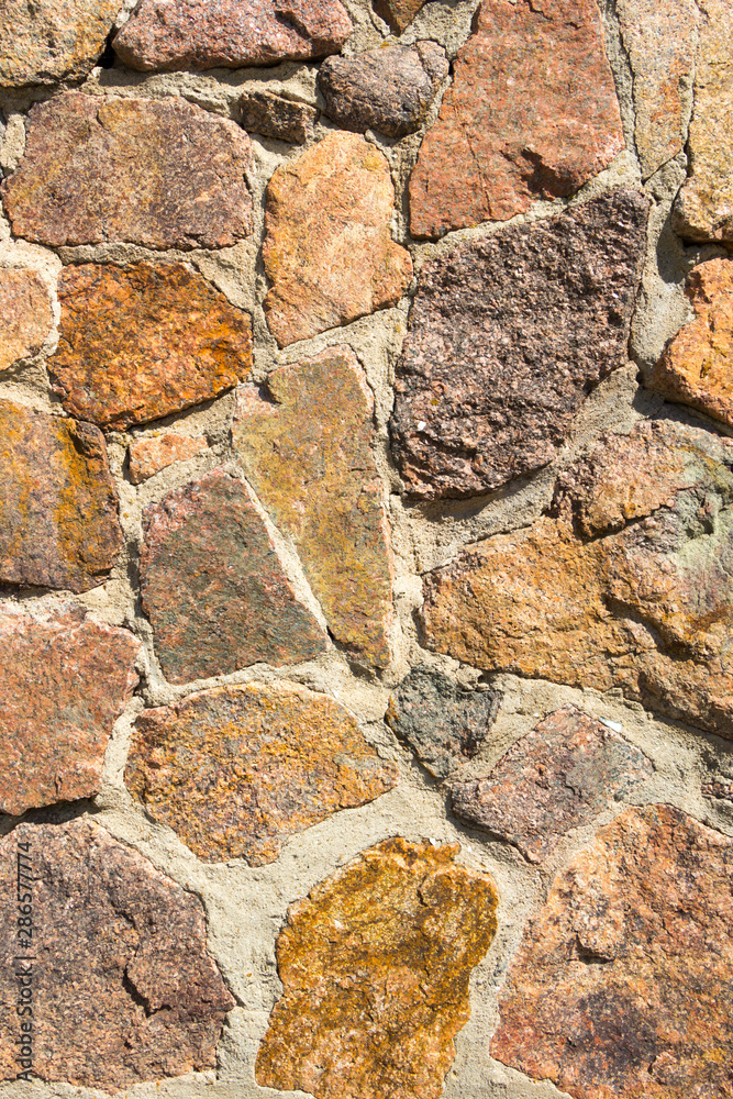 Fototapeta premium Decorative masonry from large stones background. Close-up detail view.