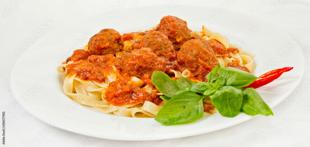 A plate of Fettuccine and Meatballs Pasta with Tomato Sauce. A plate of Fettuccine and Meatballs Pasta with Tomato Sauce.