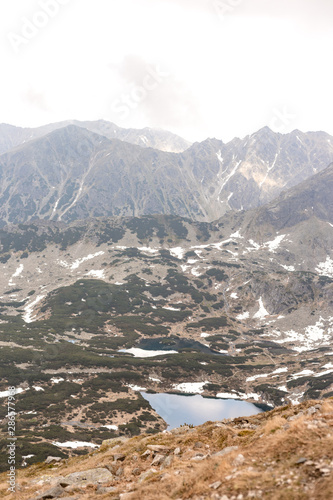 Rock Peak in the mountains. Lake Czarny Staw which is located in polish Tatra mountains © mdyn