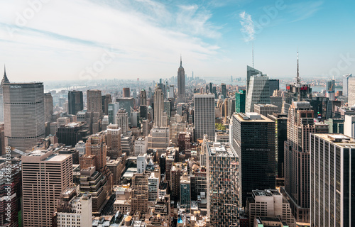 New York City Manhattan, NYC/ USA - 08 21 2017: Top of the Rock panorama view over skyline from Rockefeller center to NYC and the Empire State building on a light cloudy sunny day with blue sky