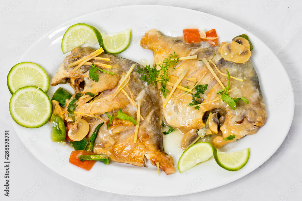 Pomfret fish pieces on plate, spicy Indian dish. Popular amongst Bengalis and south Asia for it's taste.