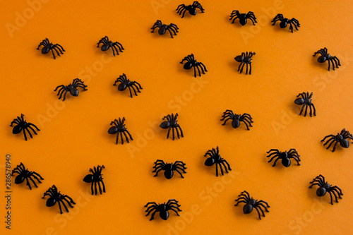 Halloween background. Spiders on an orange background. Place for text.