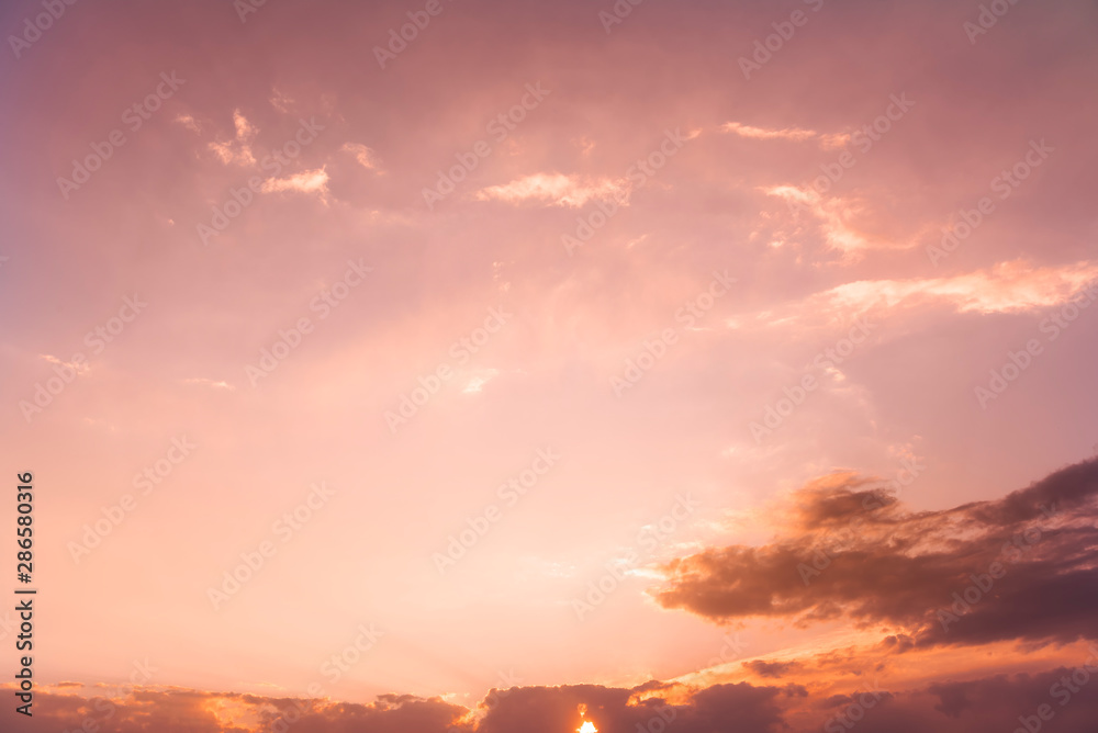 Fototapeta premium Beautiful golden sunset sky with colorful clouds.