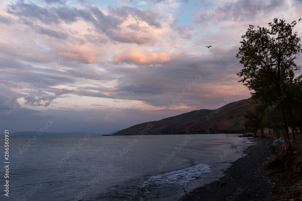 Fototapeta premium Beautiful sunset at the lake. Amazing colorful clouds after sunset at the Sevan lake Armenia.