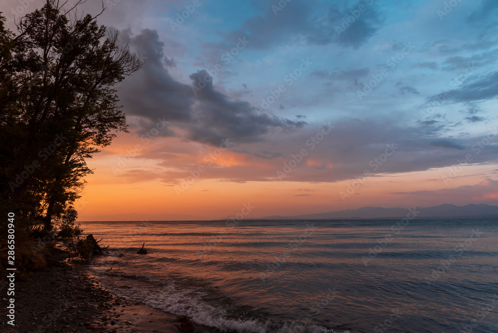 Beautiful sunset at the lake. Amazing colorful clouds after sunset at the Sevan lake Armenia. Beautiful sunset at the lake. Amazing colorful clouds after sunset at the Sevan lake Armenia.