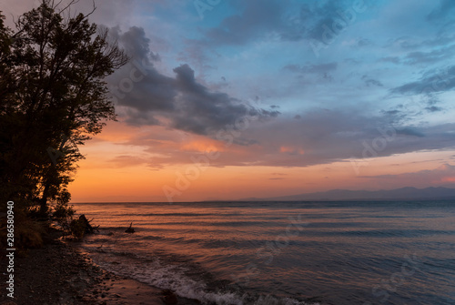 Beautiful sunset at the lake. Amazing colorful clouds after sunset at the Sevan lake Armenia.