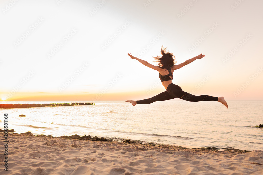 Silhouette of girl dancer in a split with sunset or sunrise background and copy space. Concept of heathy life, goob body and youth. Silhouette of girl dancer in a split with sunset or sunrise background and copy space. Concept of heathy life, goob body and youth.