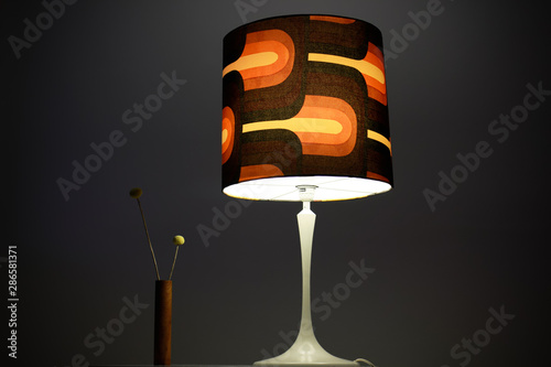 Photography a vintage midcentury lamp from the 60s with a large brown lampshade standing on