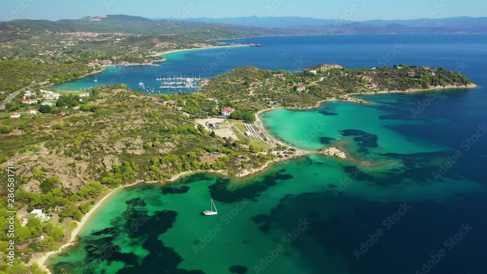 Aerial drone panoramic video of small islet complex with crystal clear turquoise sea near Diaporos island, Vourvourou, Sithonia Peninsula, Halkidiki, North Greece