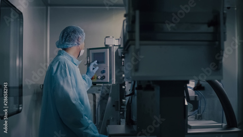 Engineer control pharmaceutical manufacturing. Factory worker operating pharmaceutical equipment. Pharmacy industry. Factory worker programming control manufacturing line.