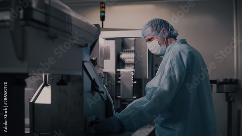 Engineer control pharmaceutical manufacturing. Factory worker operating pharmaceutical equipment. Pharmacy industry. Factory worker programming control manufacturing line.