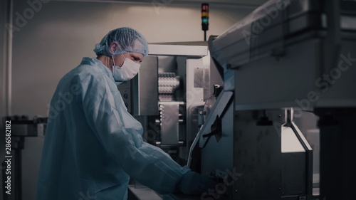 Engineer control pharmaceutical manufacturing. Factory worker operating pharmaceutical equipment. Pharmacy industry. Factory worker programming control manufacturing line.