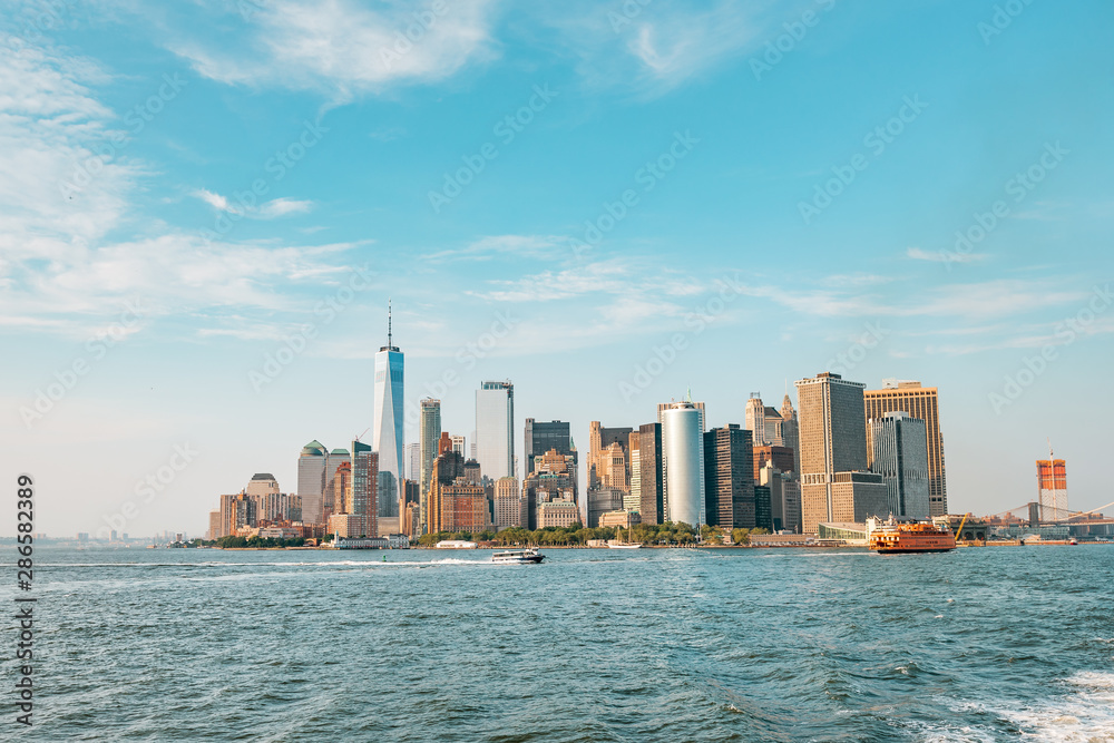 Obraz premium New York City New Jersey, NYC/ USA - 08 21 2017: Amazing sunset on New York City Hudson River on public transport staten island ferry with beautiful panorama view to NYC Manhattan skyline