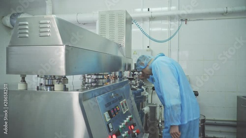 Engineer control pharmaceutical manufacturing. Factory worker operating pharmaceutical equipment. Pharmacy industry. Factory worker programming control manufacturing line.