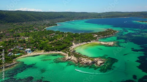 Aerial drone video of iconic bay with turquoise frozen waves of Vourvourou in Sithonia Peninsula, Halkidiki, North Greece photo