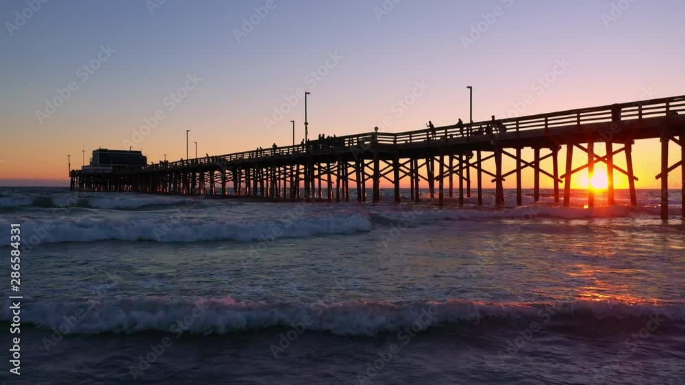 Waves rolling on the beach during sunset at Newport Beach viewing the pier. Waves rolling on the beach during sunset at Newport Beach viewing the pier.