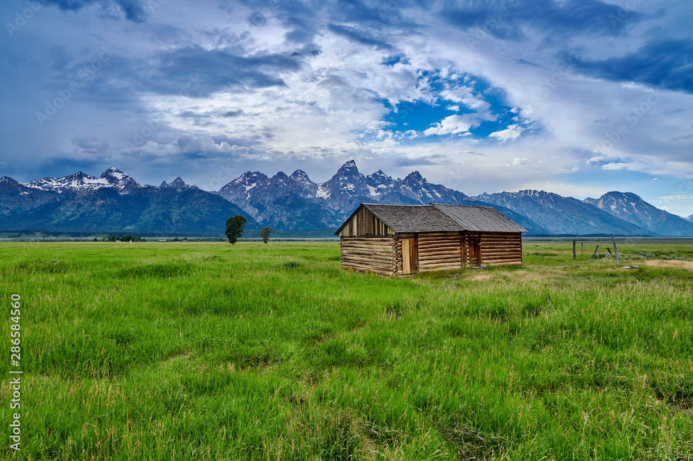 Granary with the Grand Teton mountains at Grand Teton National Park. Granary with the Grand Teton mountains at Grand Teton National Park.