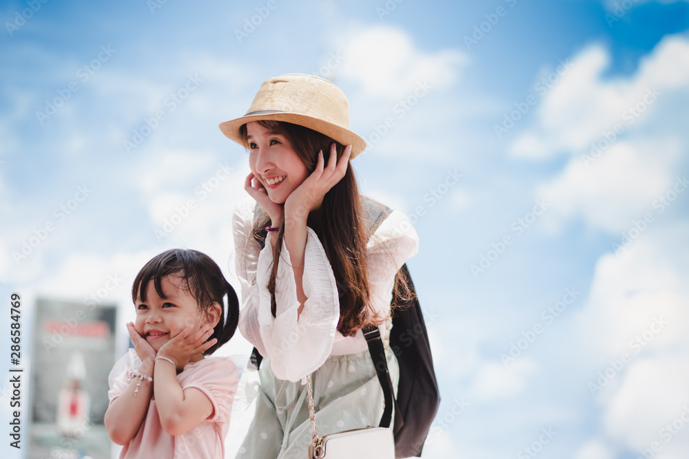 Cute baby girl and Beautiful traveler asian young woman wearing white shirt, long skirt and hat smile happily with background of city in Bangkok Thailand, Happy Travel Concept. Cute baby girl and Beautiful traveler asian young woman wearing white shirt, long skirt and hat smile happily with background of city in Bangkok Thailand, Happy Travel Concept.