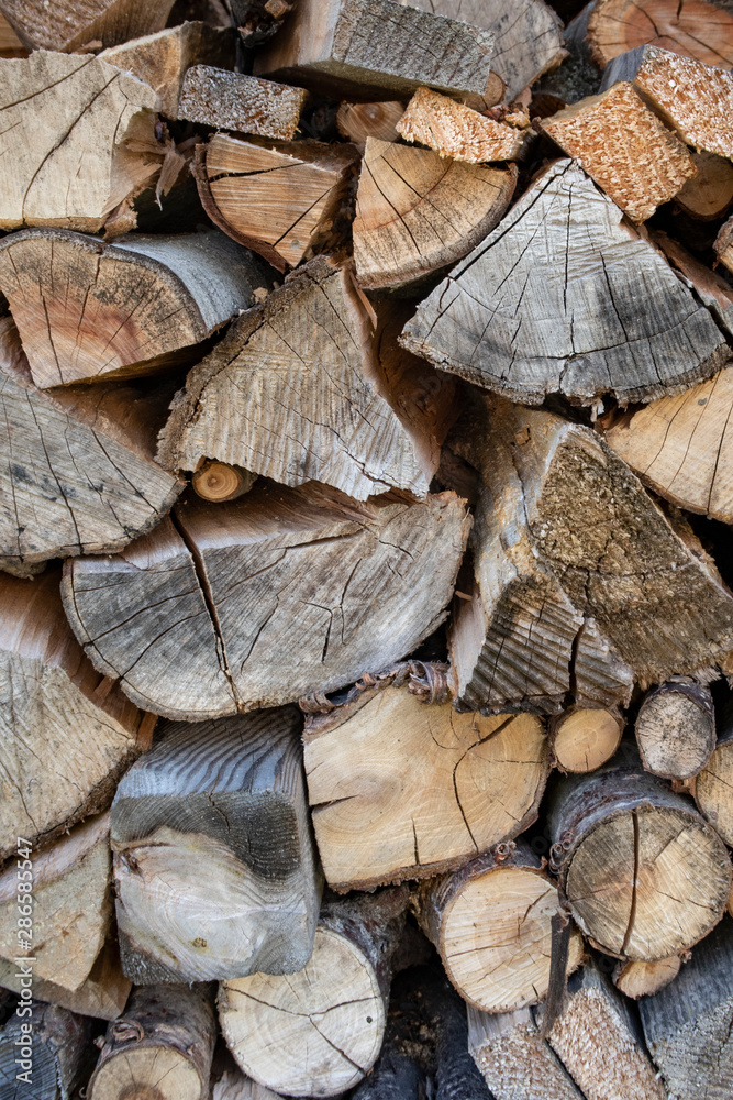 Background: Chopped wood stacked outside Background: Chopped wood stacked outside