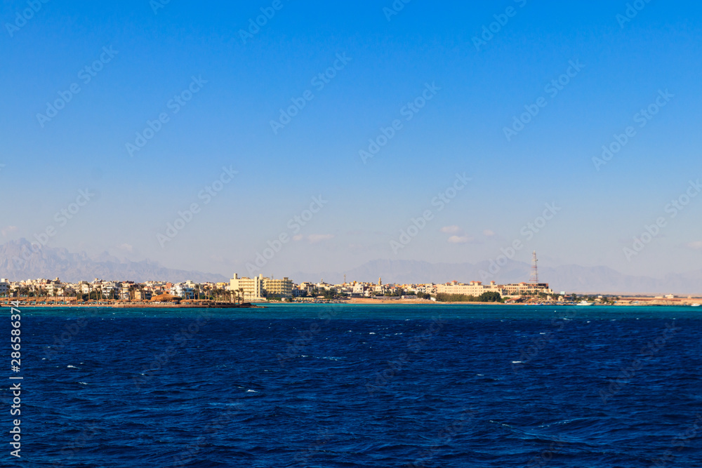 Beautiful view of the coastline with houses and hotels in Hurghada, Egypt. View from Red sea