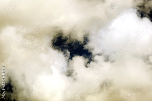 White fluffy clouds on a dark background