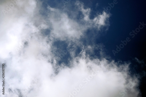 White fluffy clouds on a dark background