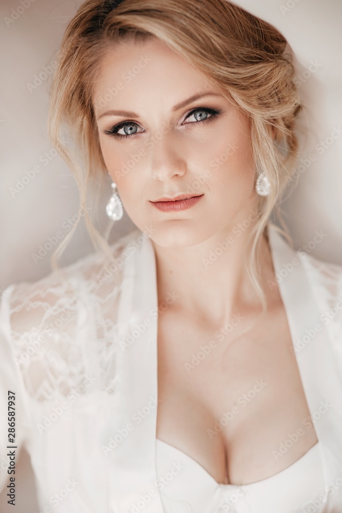 Beautiful blonde bride with stylish make-up in white dress Beautiful blonde bride with stylish make-up in white dress