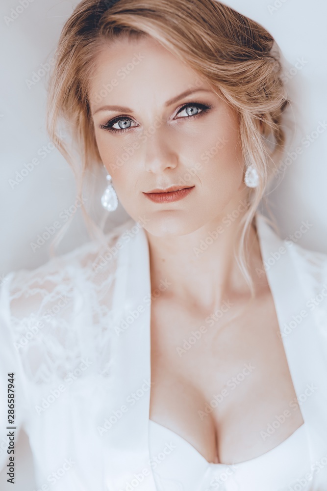 Beautiful blonde bride with stylish make-up in white dress Beautiful blonde bride with stylish make-up in white dress