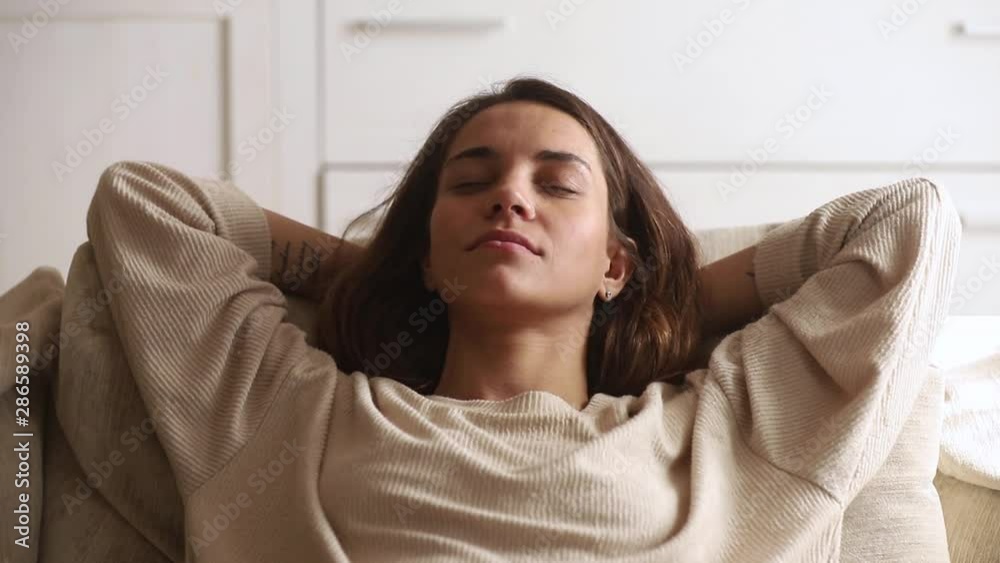 Close up view woman having day nap leaned on couch Close up view woman having day nap leaned on couch