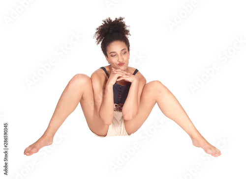 Beautiful multi-racial woman sitting on the floor legs spread