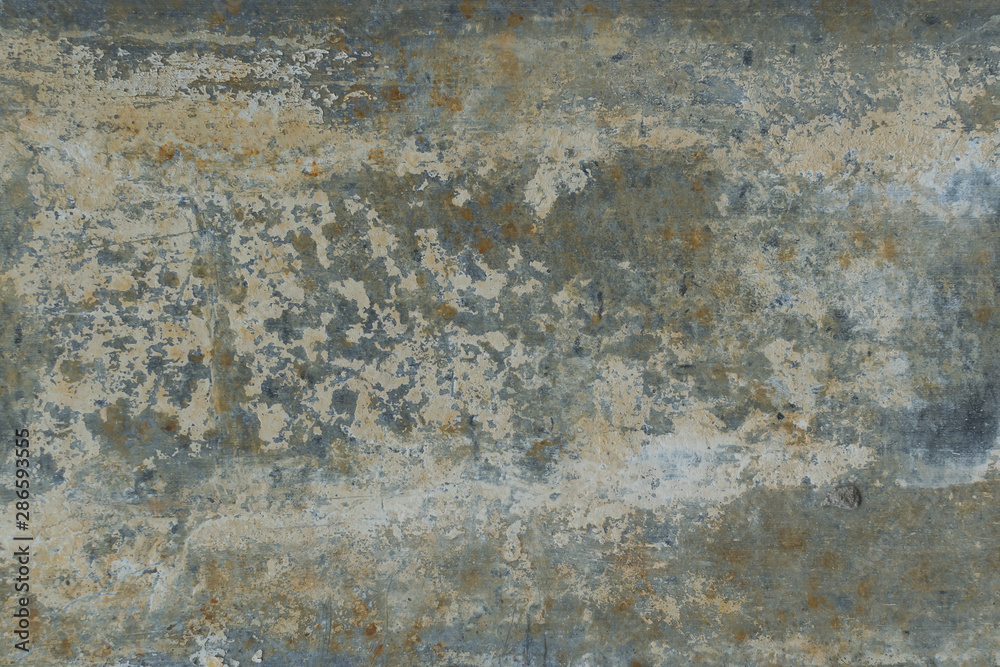 Old gray wall with yellow and brown spots as an abstract background