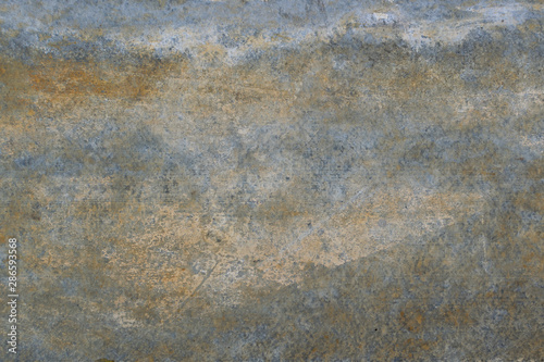 Old gray wall with yellow and brown spots as an abstract background