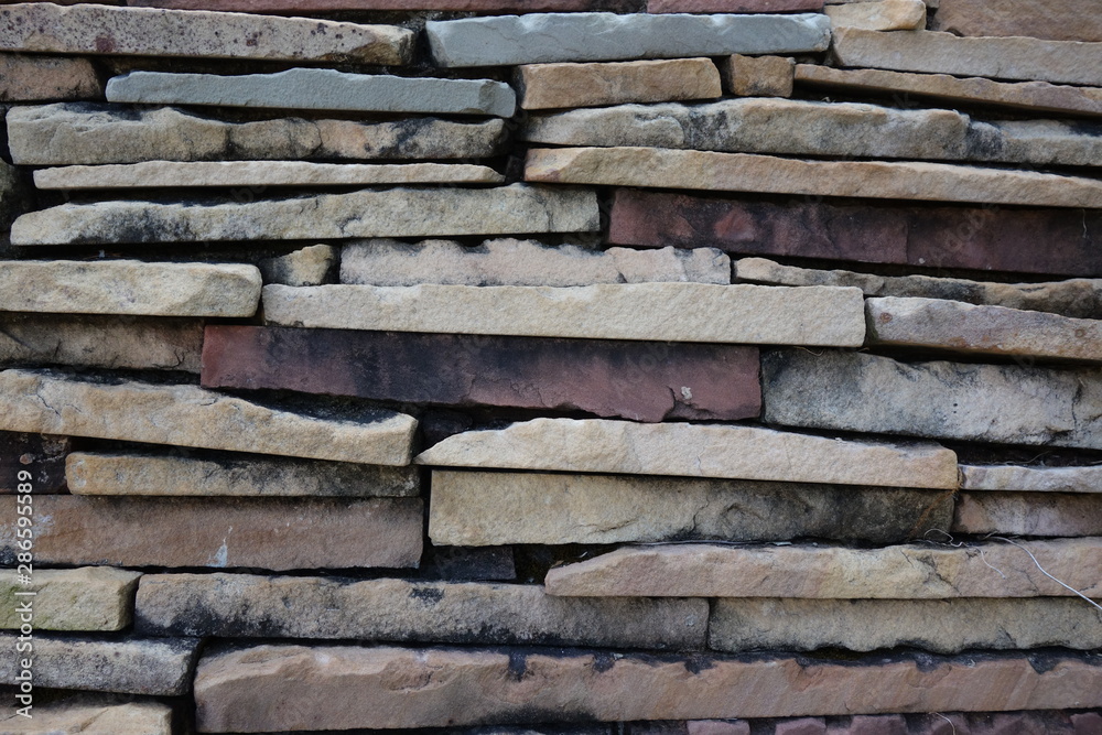 Slabs of stones background. Piling of horizontal rocks for outdoor decoration.