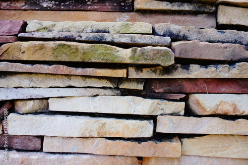 Slabs of stones background. Piling of horizontal rocks for outdoor decoration.