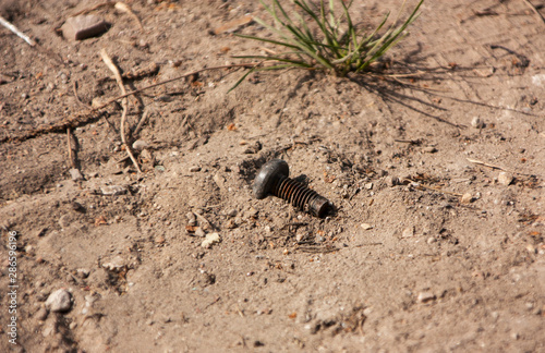 one old black bolt lies in the sand