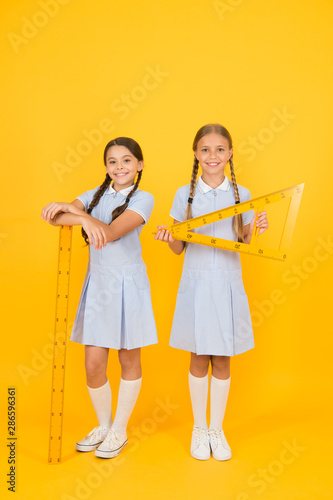 smart children at stem lesson. girls love geometry. old school. modern education. happy friends in retro uniform. vintage kid fashion. back to school. small girls hold math tools. STEM disciplines © be free
