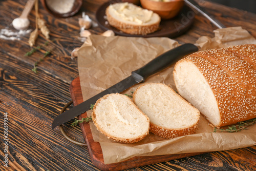 Wallpaper Mural Sliced fresh bread with knife on wooden table Torontodigital.ca