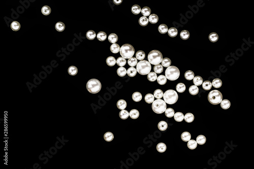 scattered pearls on a black background