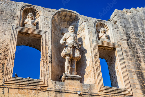 The courtyard of the castle, or ducal palace, of the Castromediano Lymburgh, in Cavallino, Lecce, Puglia, Salento, Italy. Empty windows and niches with stone statues. photo