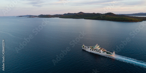 Canvas Print Aerial view of car ferry with Ugljan island in background at dusk, Croatia