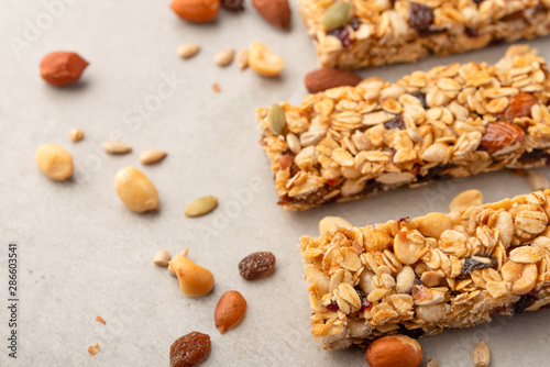 granola bars with nuts on a light background with space for design, horizontal photo, diet, proper nutrition