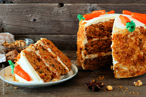 Cuadro en lienzo Slice of homemade carrot cake with cream cheese frosting and fondant carrots