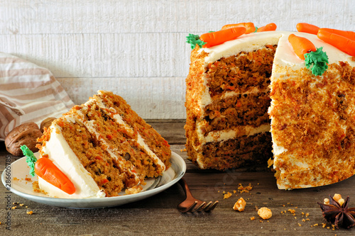 Cuadro en lienzo Slice of homemade carrot cake with cream cheese frosting and fondant carrots