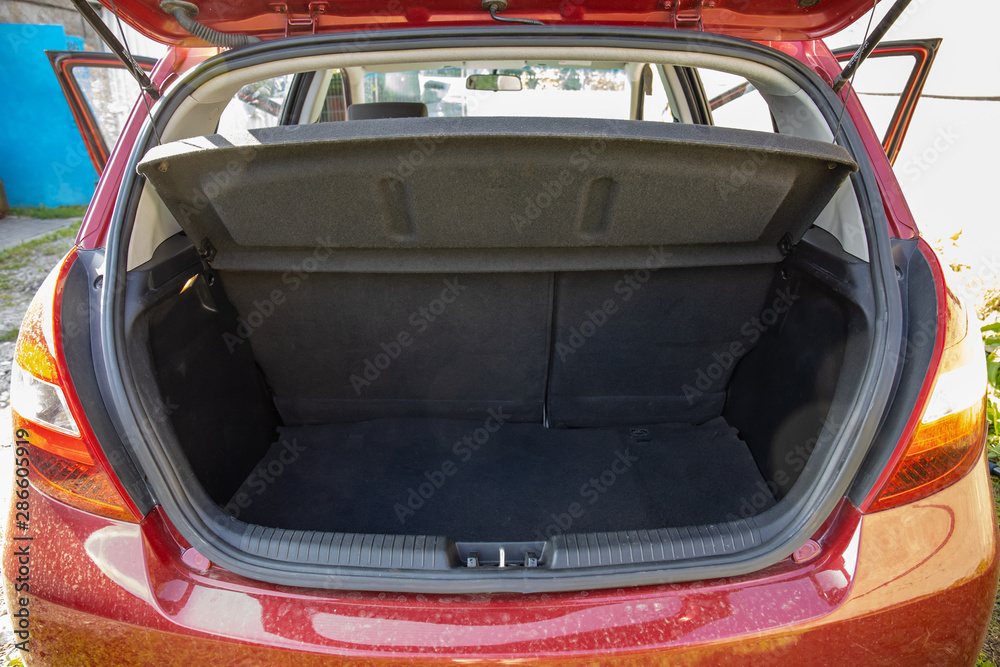 open empty trunk of a red car open empty trunk of a red car