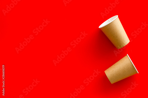 paper cups for coffee to take away on red background copyspace