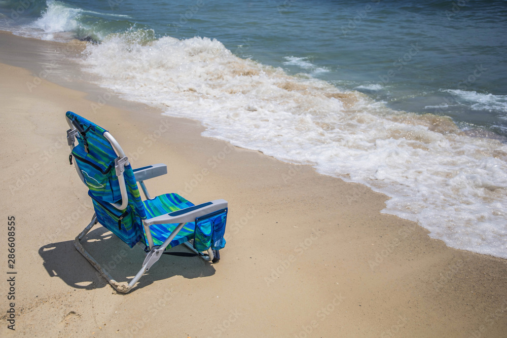 Lone empty chair at the beach Lone empty chair at the beach