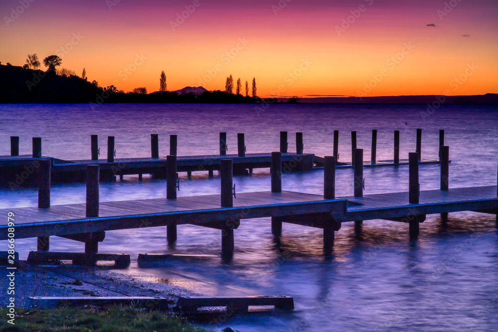 Dramatic colours of pre dawn over the piers and jetty at Turangi Lake Taupo New Zealand