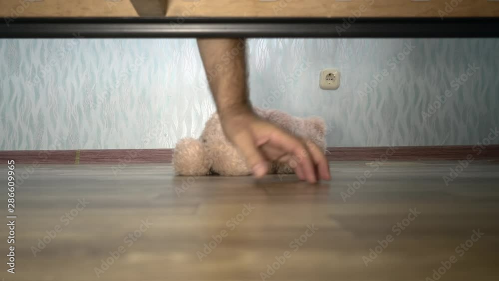 mens hand looking under the bed Teddy bear Wake up Protection Morning Sleep Awakening Concept Insomnia mens hand looking under the bed Teddy bear Wake up Protection Morning Sleep Awakening Concept Insomnia