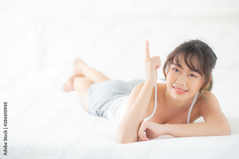 Portrait beautiful young asian woman smile wake up healthy and wellness at morning, beauty asia girl lying and pointing something skin care and makeup cosmetic with happy, lifestyle and relax concept. Portrait beautiful young asian woman smile wake up healthy and wellness at morning, beauty asia girl lying and pointing something skin care and makeup cosmetic with happy, lifestyle and relax concept.